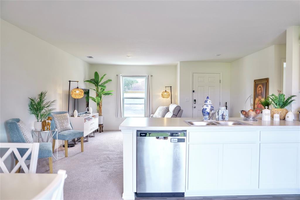 1229 Southwest San Antonio Avenue Port St. Lucie, FL 34953 - Photo 10 of 31 a living room with furniture a potted plant and a kitchen view