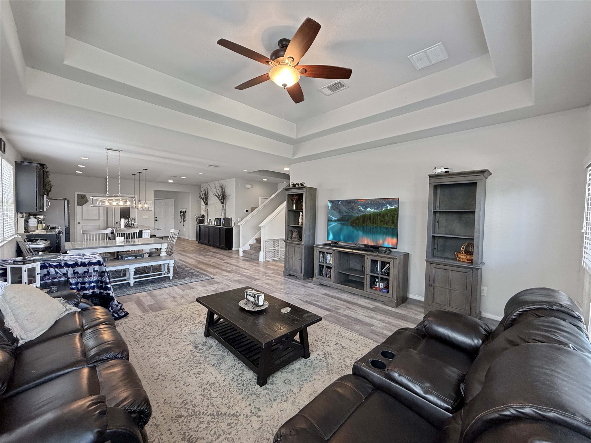 429 Rusk Bluff Avenue Leander, TX 78641 - Photo 6 of 24 An inviting open-concept layout connects the kitchen, dining, and living areas with cohesive flooring.