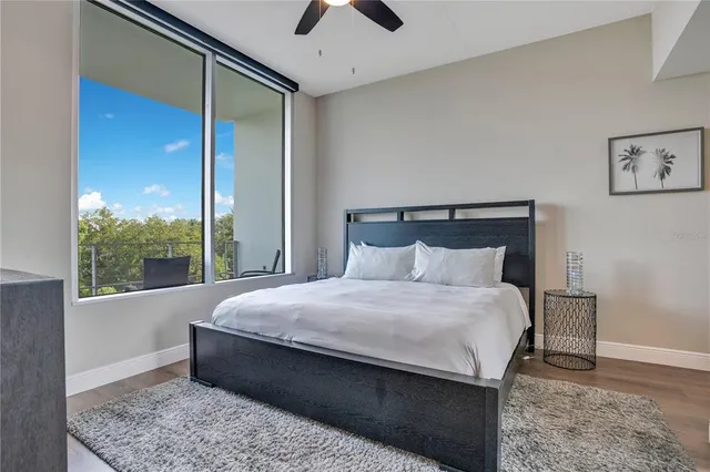 a bedroom with a bed window and a flat screen tv