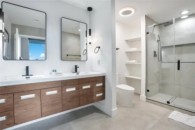 a bathroom with a shower a toilet and a sink