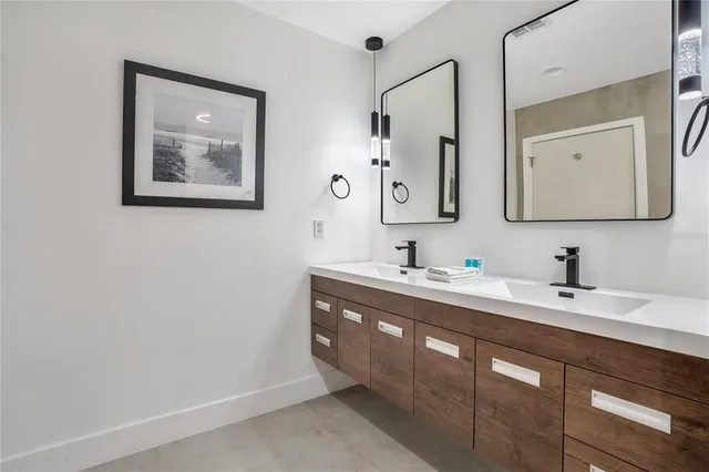 a bedroom with a bed and a night stand