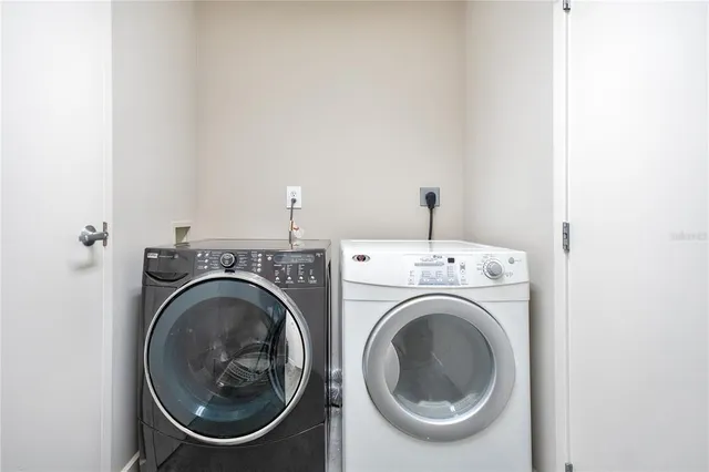 a dining room with furniture and a floor to ceiling window