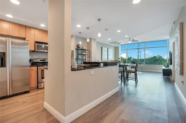 a kitchen with stainless steel appliances granite countertop a stove a sink and a microwave