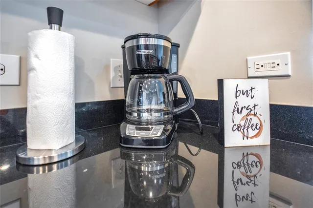 a large kitchen with stainless steel appliances granite countertop a stove a sink and a refrigerator