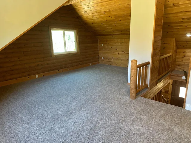 a bathroom with a tub a window and a shower