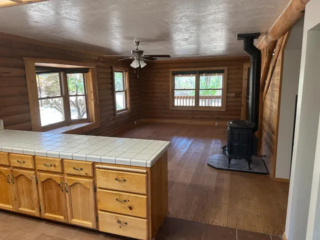 a view of a kitchen with a sink and a fireplace