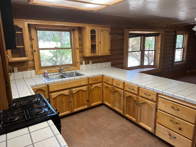 a view of entryway and kitchen with wooden floor