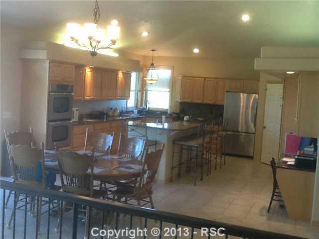 16835 Roller Coaster Road Colorado Springs, CO 80921 - Photo 11 of 25 Tile Floors-Stainless Steel Appliances-Double Oven-Vegetable sink-Built in office nook-Walk out to deck with spectacular views!