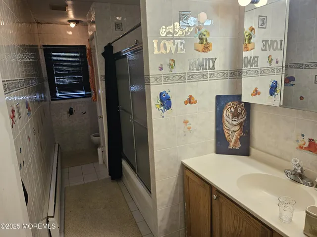 a bathroom with a sink a toilet and a shower