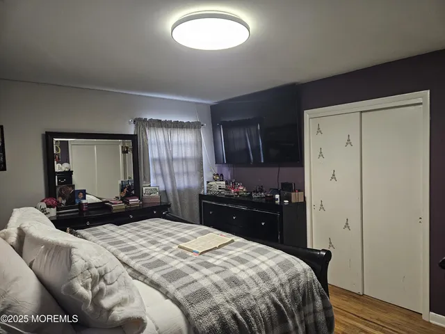 a bedroom with a bed and a dresser