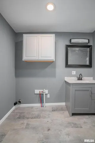 a bathroom with a sink vanity and mirror