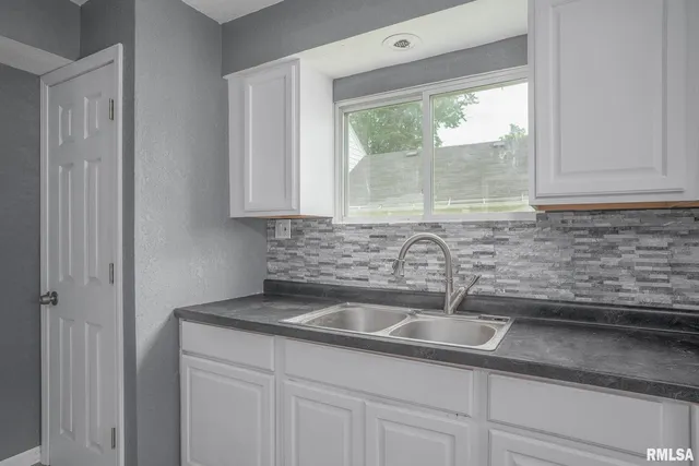 a kitchen with a sink and cabinets