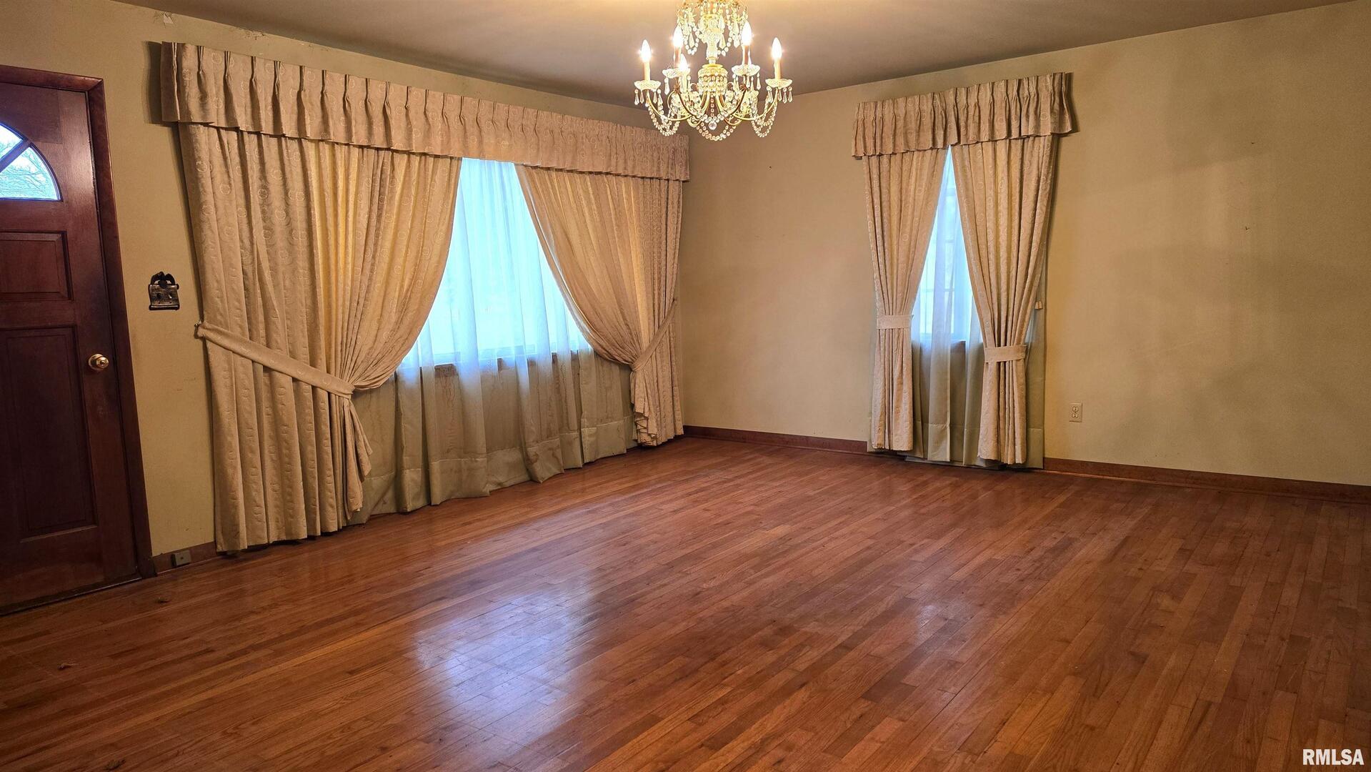 1028 Coyne Center Road Milan, IL 61264 - Photo 3 of 21 a view of a room with wooden floor staircase and windows