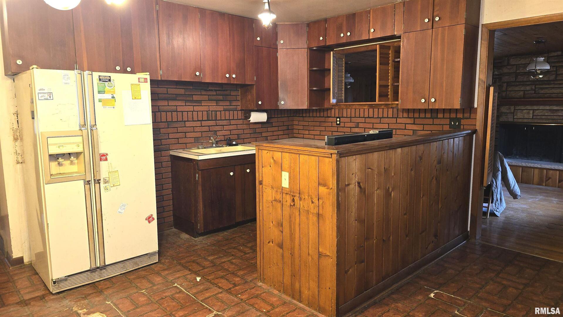 1028 Coyne Center Road Milan, IL 61264 - Photo 6 of 21 a kitchen with stainless steel appliances granite countertop a refrigerator and a sink