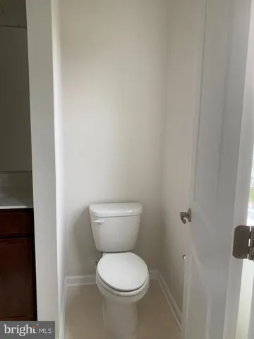 a a toilet sitting in a bathroom next to a sink
