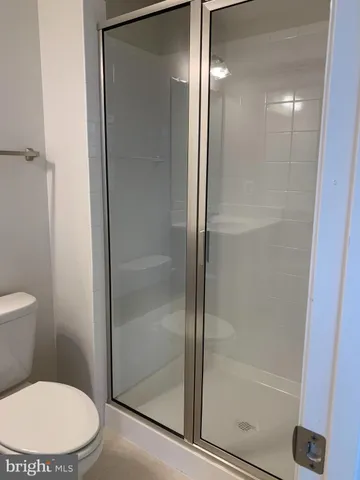 a bathroom with a toilet and a shower