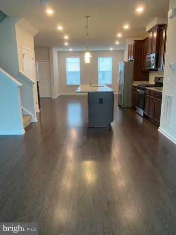 a view of a kitchen with a sink and a refrigerator