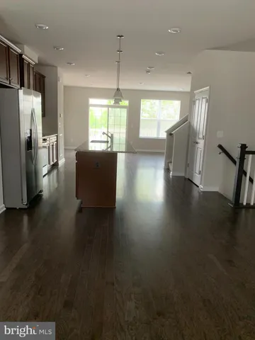 a view of a livingroom with furniture wooden floor and windows