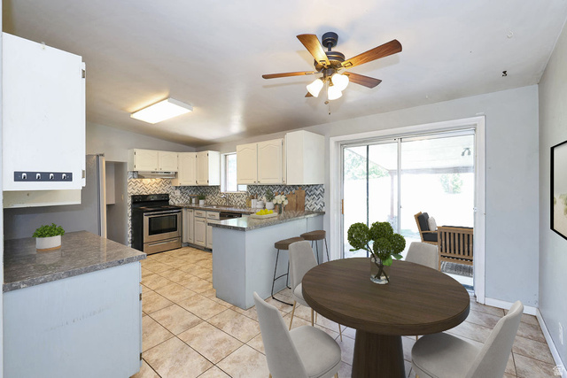 1272 Cook Street Ogden, UT 84404 - Photo 13 of 58 Kitchen with white cabinetry, stainless steel range, and tile backsplash