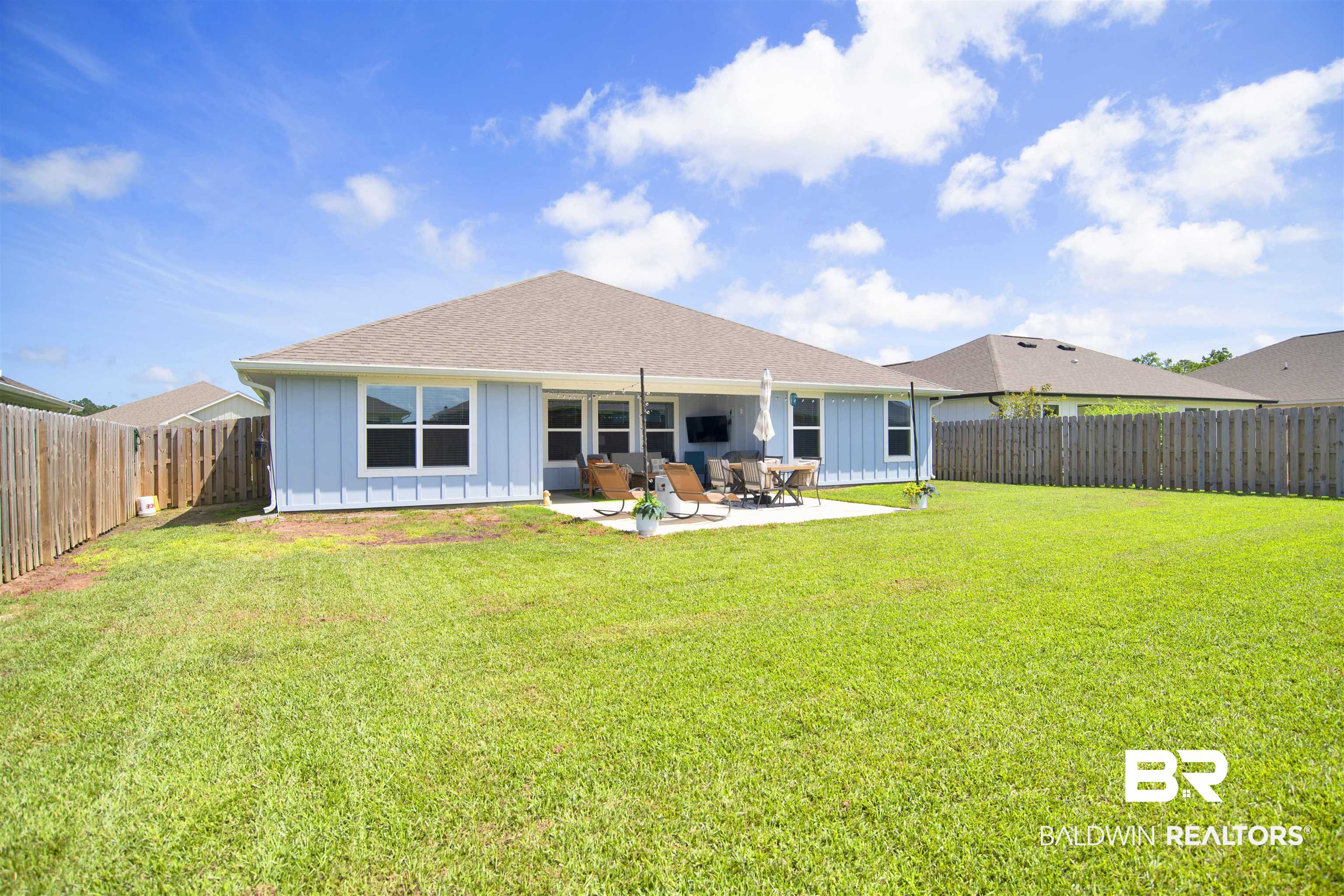 22301 Early Dawn Circle Foley, AL 36535 - Photo 35 of 45 Expansive backyard featuring a large concrete patio, full privacy fencing, and ample green space
