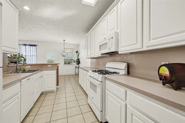 a kitchen with a white cabinets and appliances