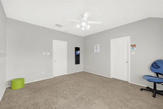 a view of a livingroom with a furniture and fan