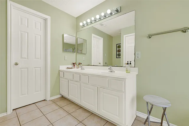 a bathroom with a double vanity sink and a mirror