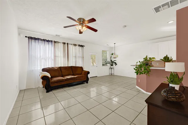 a living room with furniture and a potted plant