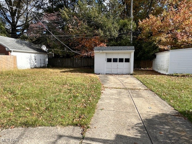 1183 Argonne Road Cleveland, OH 44121 - Photo 15 of 18 View of yard with an outdoor structure, driveway, and view of scattered trees