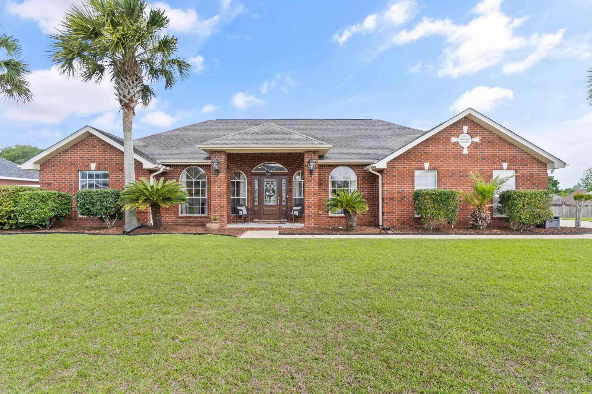 4248 Chittingham Drive Pace, FL 32571 - Photo 1 of 43 a front view of house with yard and outdoor seating