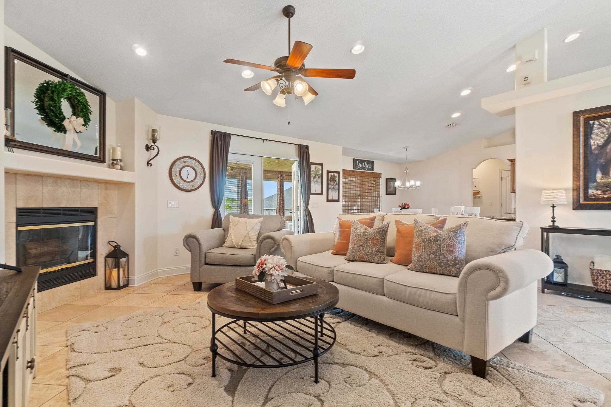 4248 Chittingham Drive Pace, FL 32571 - Photo 19 of 43 a living room with furniture a fireplace and a flat screen tv