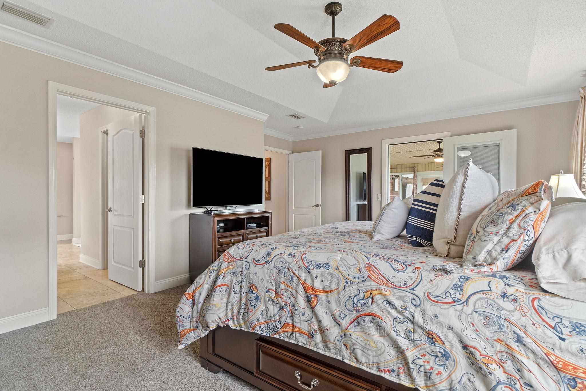 4248 Chittingham Drive Pace, FL 32571 - Photo 22 of 43 a bedroom with a bed and a flat screen tv