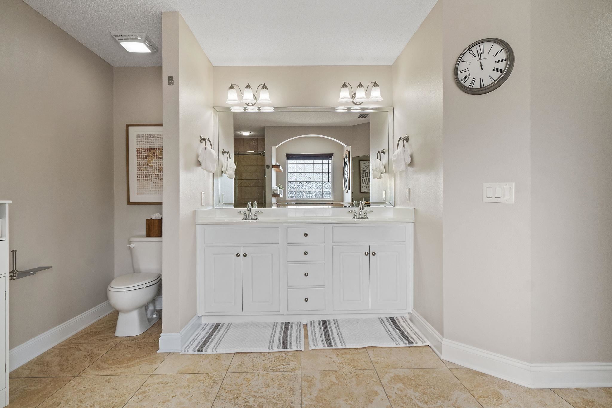 4248 Chittingham Drive Pace, FL 32571 - Photo 25 of 43 a spacious bathroom with a toilet sink and mirror