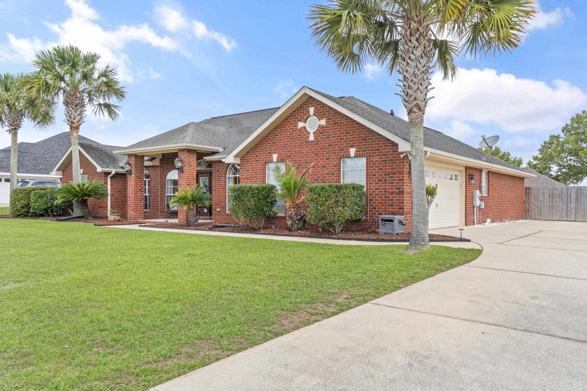 4248 Chittingham Drive Pace, FL 32571 - Photo 3 of 43 a front view of a house with a yard and garage