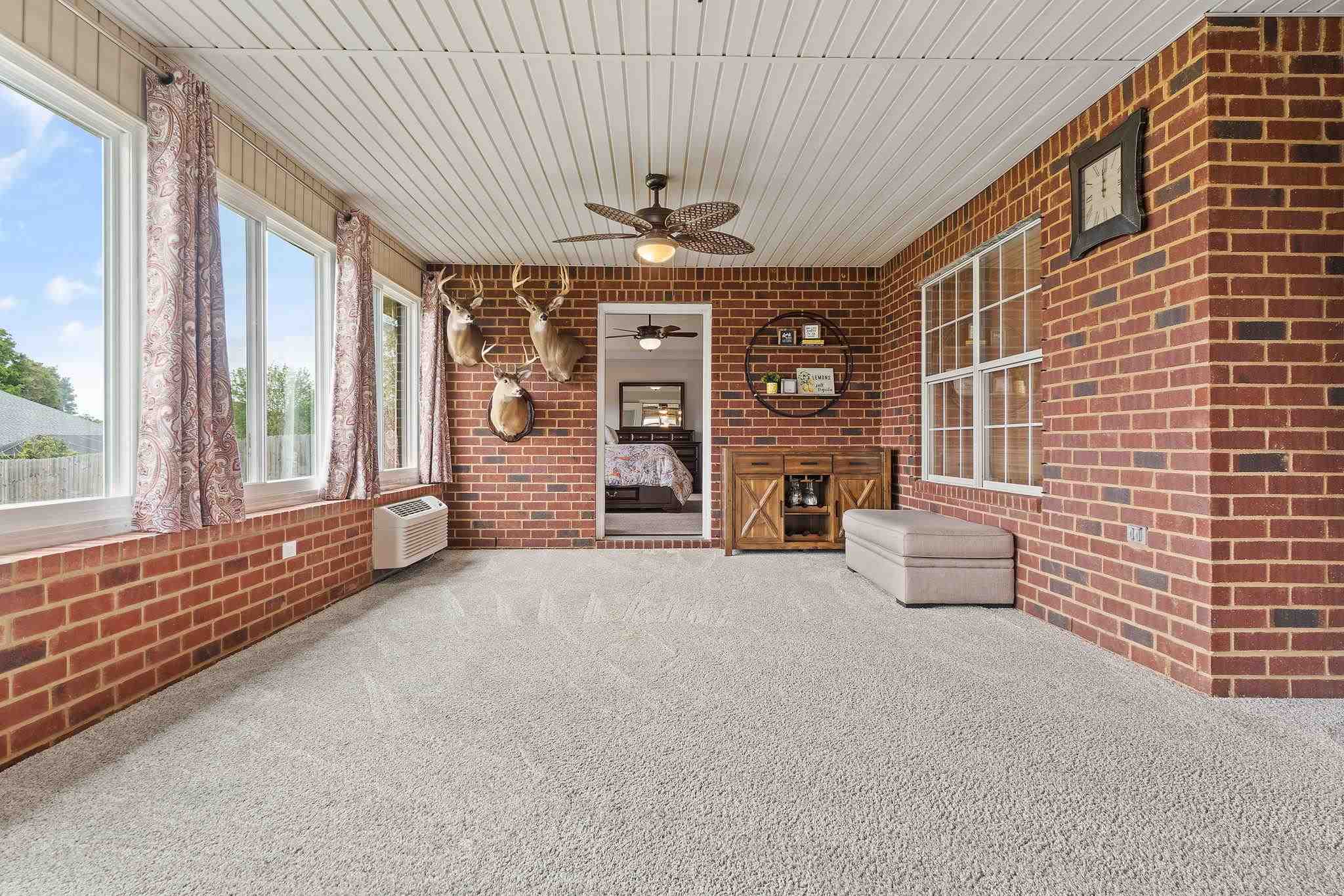 4248 Chittingham Drive Pace, FL 32571 - Photo 33 of 43 a view of an empty room with a fireplace and a large window