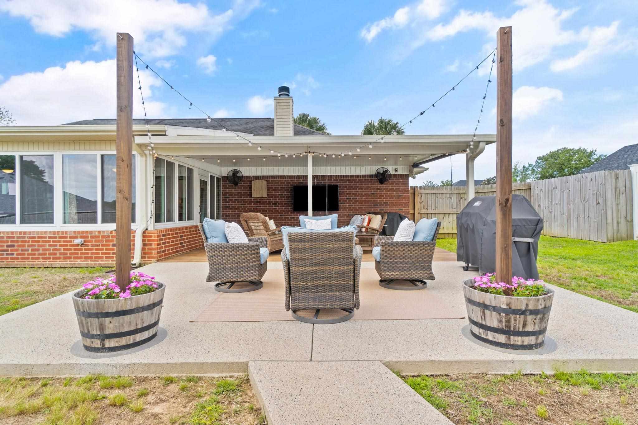 4248 Chittingham Drive Pace, FL 32571 - Photo 38 of 43 a view of a patio with couches chairs and potted plants
