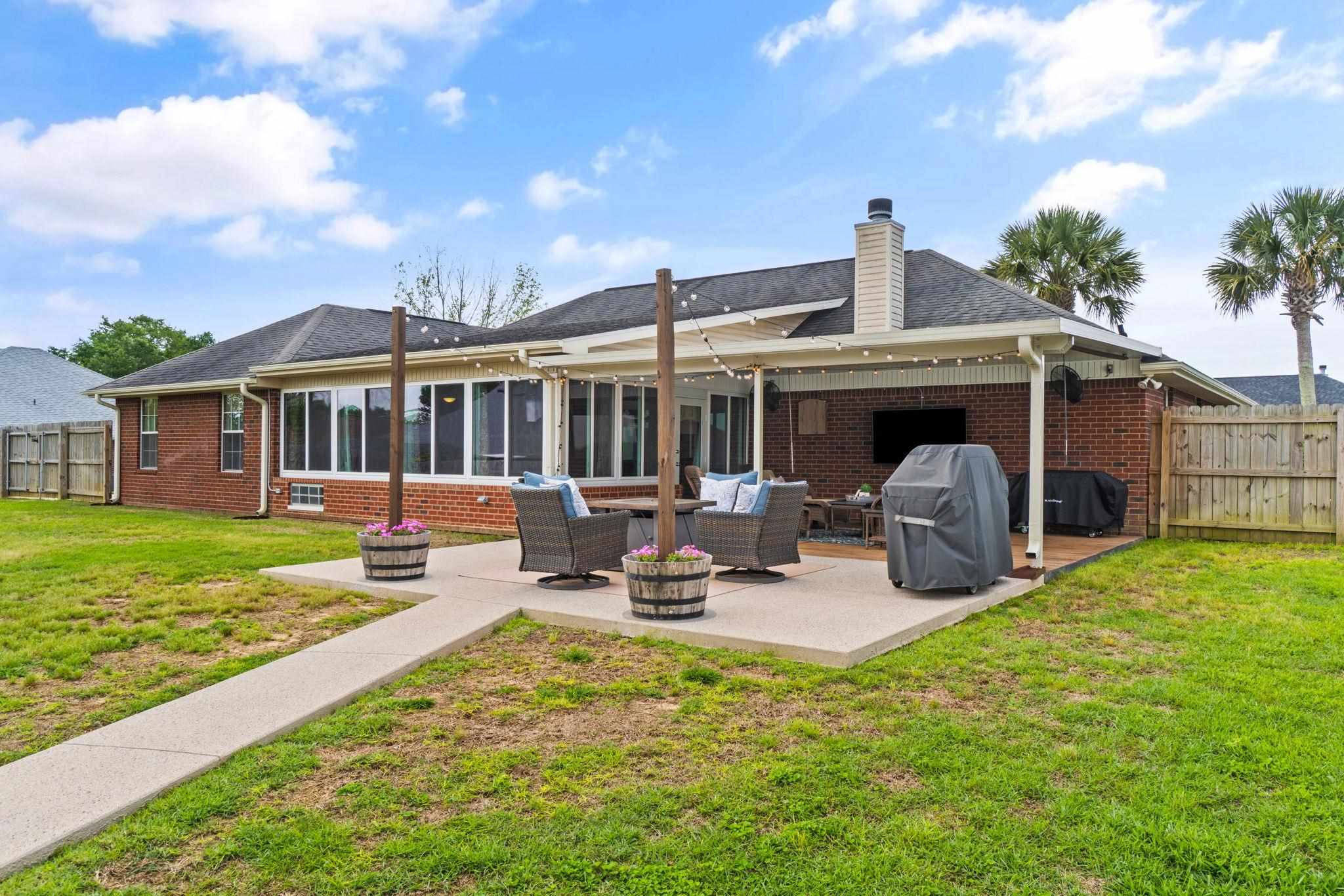 4248 Chittingham Drive Pace, FL 32571 - Photo 40 of 43 a view of a house with backyard porch and sitting area