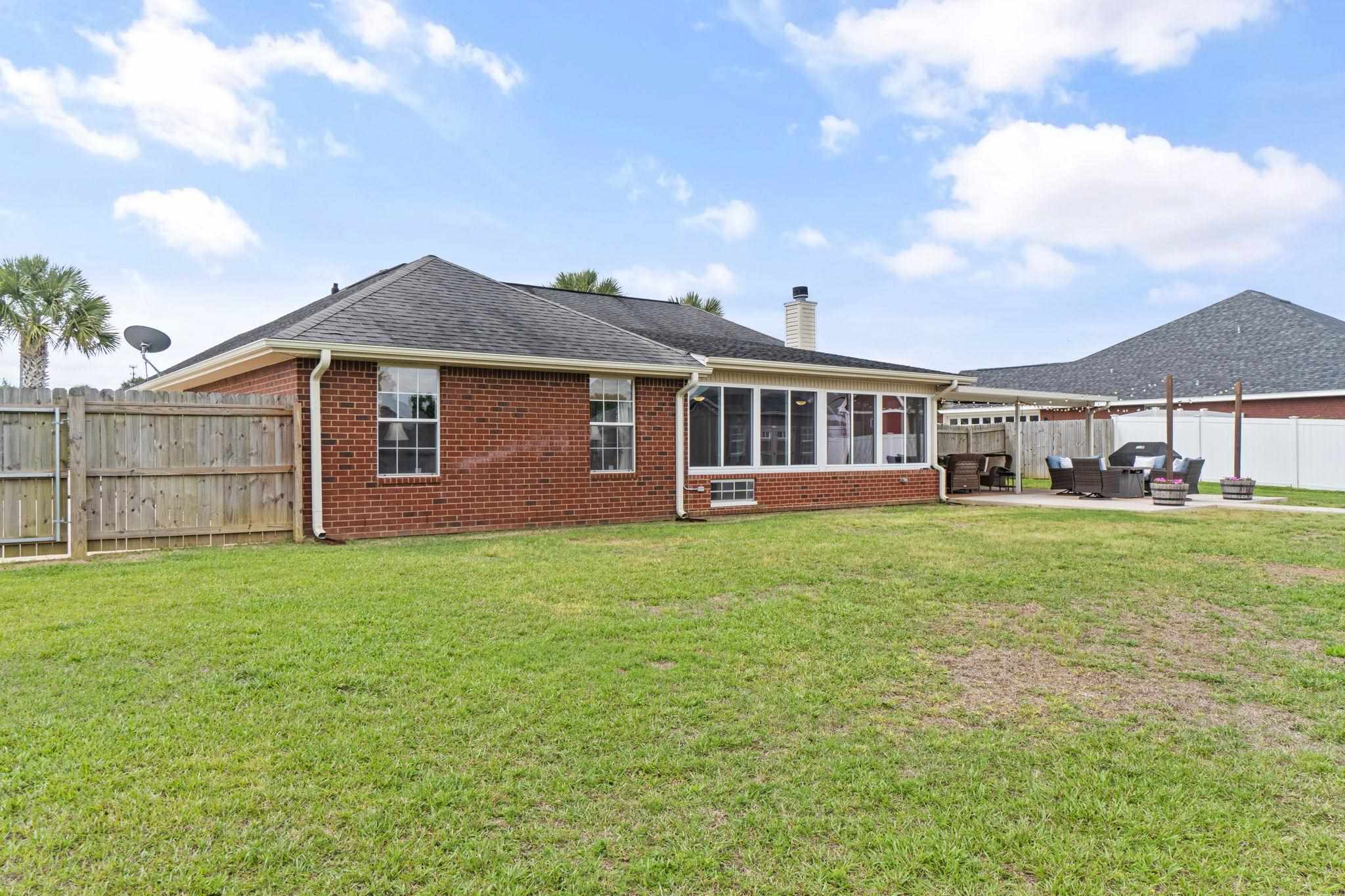 4248 Chittingham Drive Pace, FL 32571 - Photo 42 of 43 a front view of a house with a garden