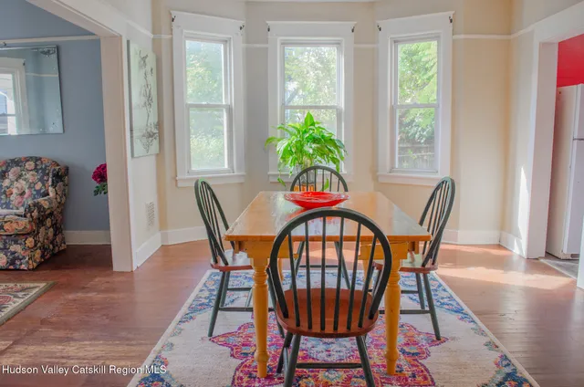 a view of a dining room with furniture and a potted plant