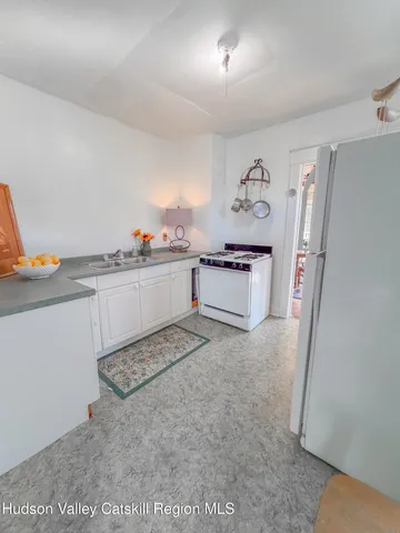 a kitchen with stainless steel appliances granite countertop a refrigerator and a stove