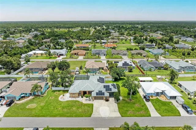 an aerial view of residential houses with outdoor space