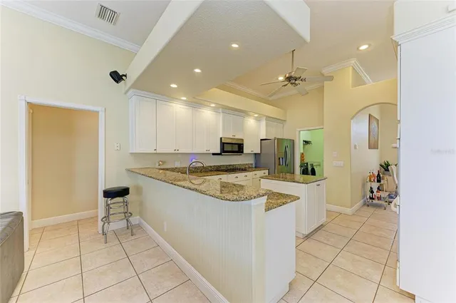 a kitchen with a refrigerator sink and microwave