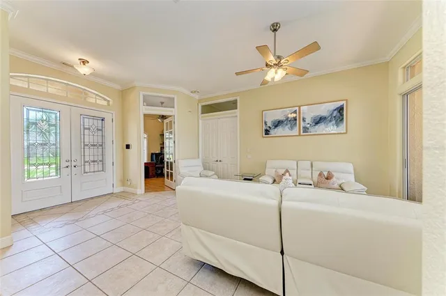 a living room with furniture and a chandelier