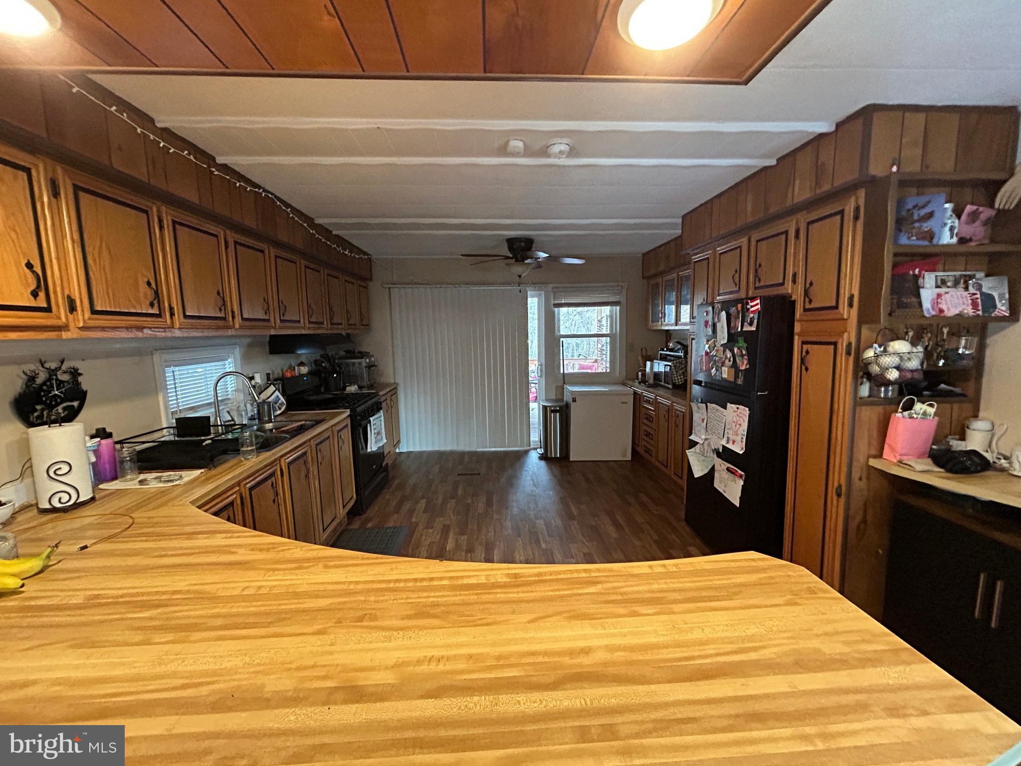 4743-4745 Chambersburg Road Biglerville, PA 17307 - Photo 14 of 101 a kitchen with stainless steel appliances kitchen island granite countertop a refrigerator stove oven a sink dishwasher and cabinets with wooden floor