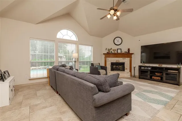a living room with furniture a fireplace and a flat screen tv