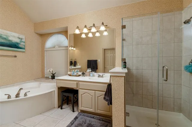 a bathroom with a bathtub sink and mirror
