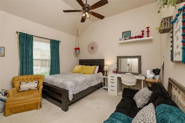 a bedroom with a bed couch and window