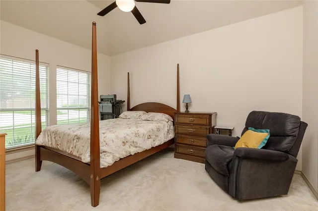 a bedroom with bed couch and window