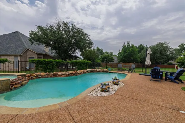 an outdoor space with swimming pool and furniture