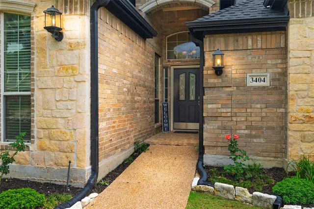 a pathway of a house with a yard